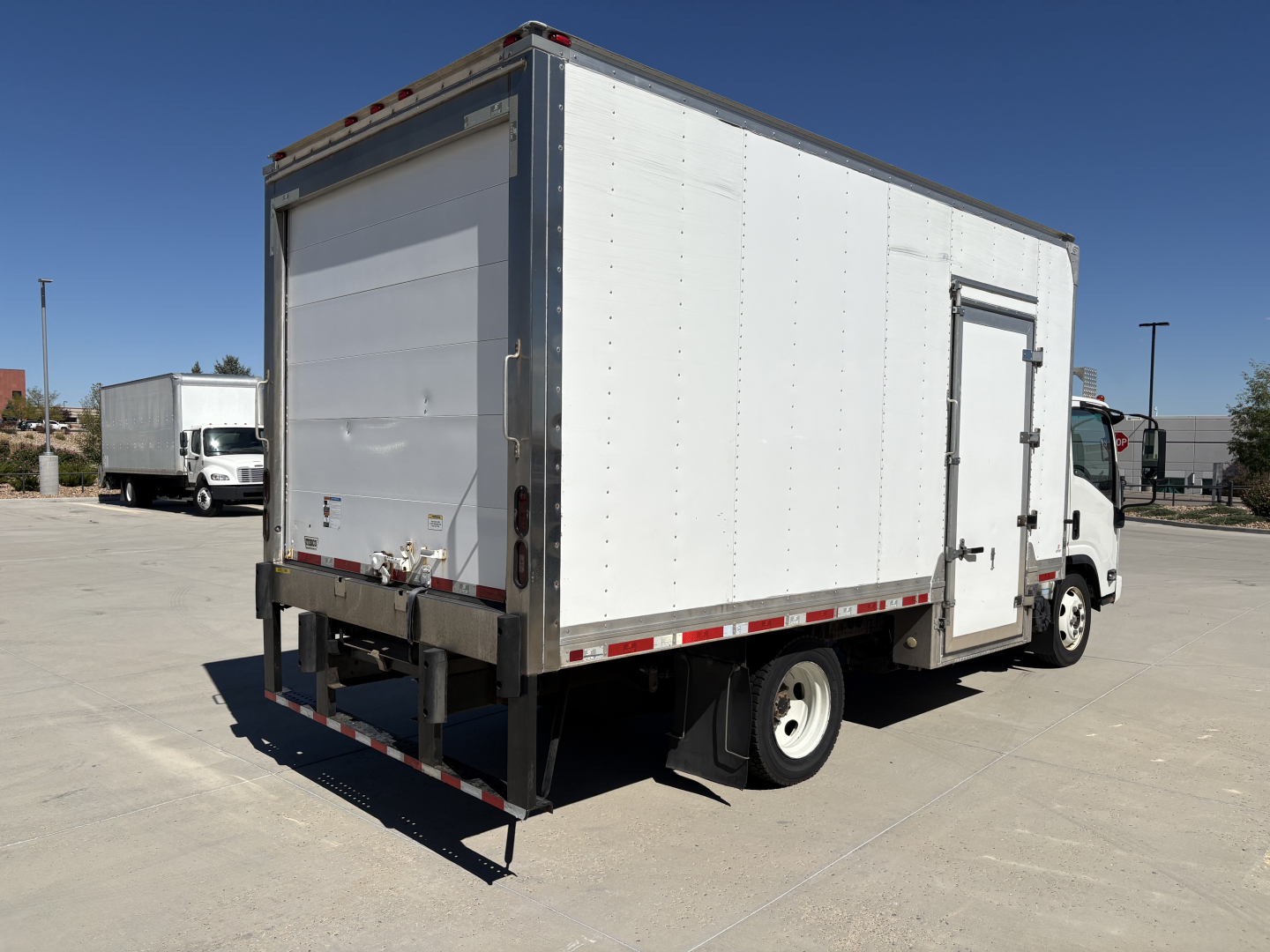 Rear and side view of a 2020 Chevrolet W4500 refrigerated truck displaying a white box body, rear liftgate, and side door.