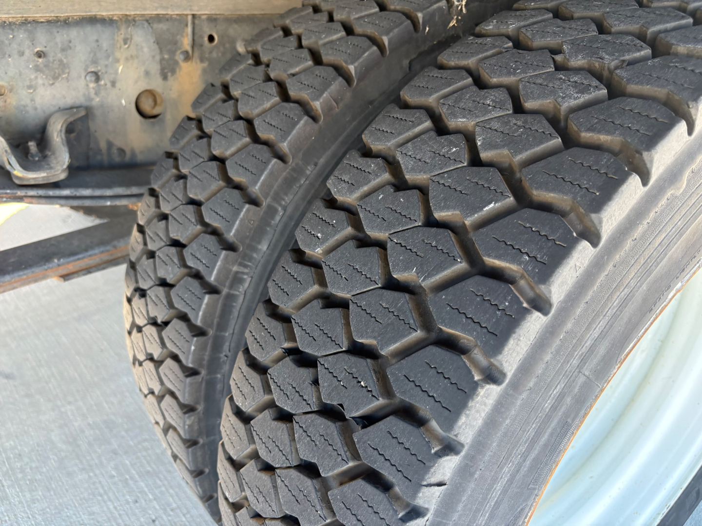 Chevrolet W4500 chassis with dual rear tires showing heavy tread pattern and wheel well; no text visible on components.