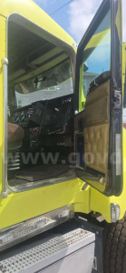Kenworth T600 truck cabin doorway open showing interior dashboard and door panel