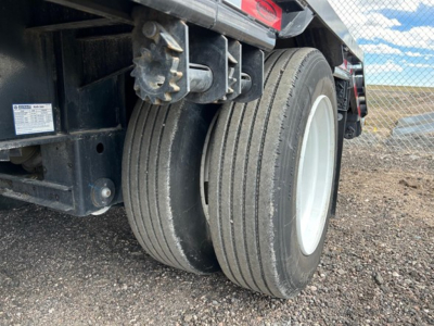 Dual rear wheels of a used drop deck trailer with rugged tires and white rims, part of a Dura Haul steel drop deck trailer.