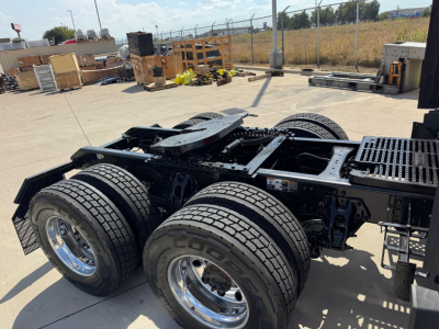 Kenworth T680 chassis view showing dual rear axles and tires, no cab attached, with front chassis and fifth wheel visible.
