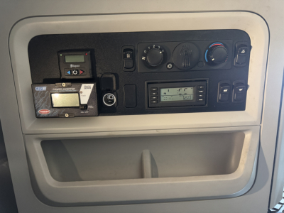 Kenworth T680 dash cluster with controls and digital display in cab interior