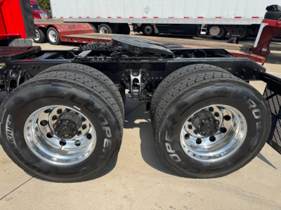 Kenworth T680 chassis showing dual rear axles with large Goodyear tires and polished wheels.