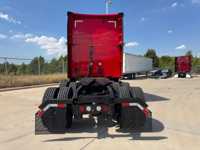 Kenworth T680 chassis with red sleeper cab, rear view showing dual rear axles and mud flaps.