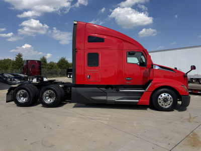 Kenworth T680 sleeper cab truck side view showing red tractor with black lower cab and wheel arches.