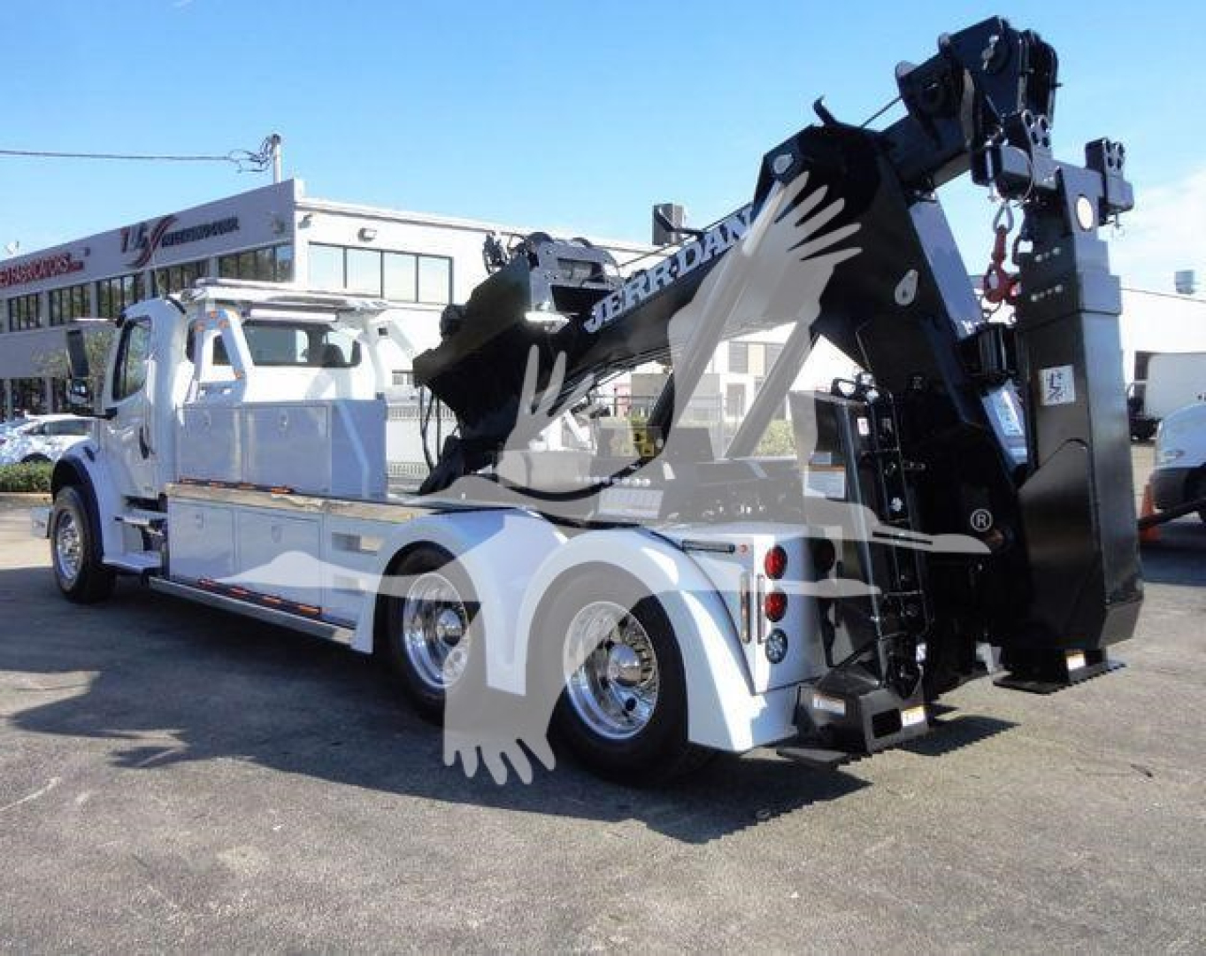 Freightliner Business Class M2 106 tow truck with hydraulic mid-reach crane and winch, side view showing white body and black crane assembly.