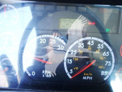Freightliner 2012 Business Class M2 106 gauge cluster showing RPM and speedometer, digital odometer, tachometer dials, and warning indicator.