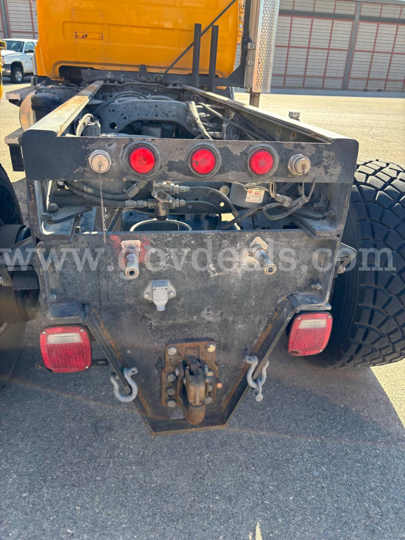 Truck rear frame of a 1996 Mack RD688P chassis showing taillights, hitch, and wiring harness.