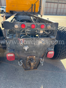 Truck rear frame of a 1996 Mack RD688P chassis showing taillights, hitch, and wiring harness.
