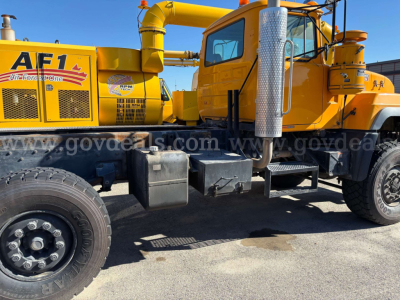Mack RD688P cab and chassis truck showing AF1 air compressor and side fuel tank with steps and exhaust stack.
