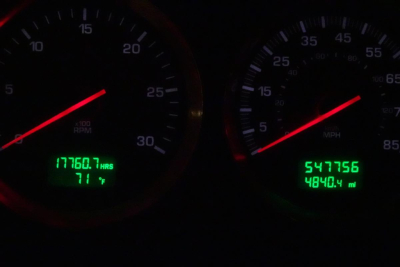 Dashboard gauges illuminated in green with odometer and hour meter readings. Left gauge shows 17760.7 hrs and 71°F. Right gauge shows 547756 miles and 4840.4 mi.
