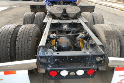 Kenworth T660 tractor rear chassis showing dual rear axles and fifth wheel, with back-of-cab components and lights.