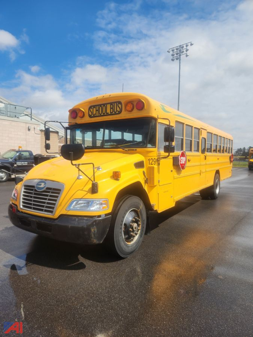 Yellow 2016 Blue Bird Vision school bus shown from front-left, with 'SCHOOL BUS' sign and stop arm visible.