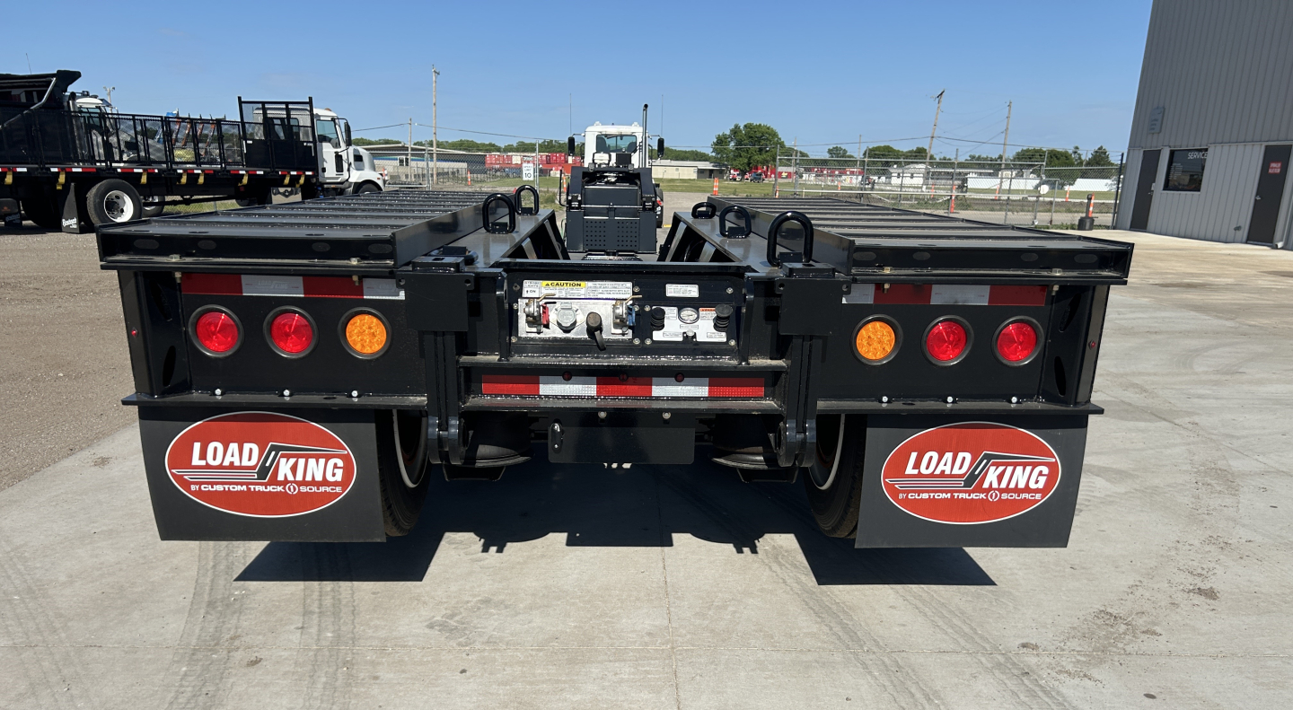 Load King trailer rear view showing dual rear fenders with Load King logo mud flaps, LED taillights, and rear bumper with hitch area.