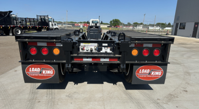 Load King trailer rear view showing dual rear fenders with Load King logo mud flaps, LED taillights, and rear bumper with hitch area.
