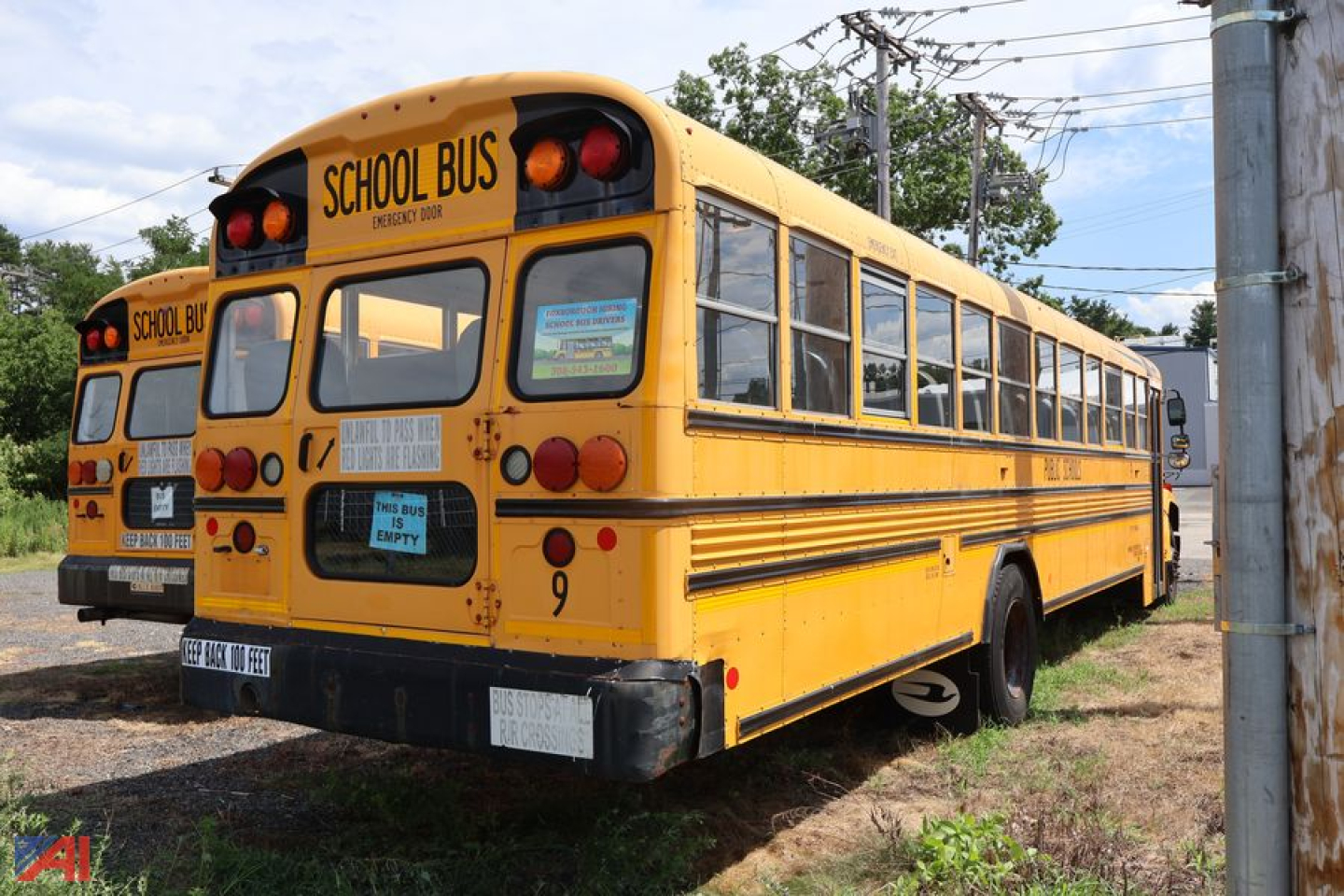 School bus rear and side view showing yellow body, 'SCHOOL BUS' signage, rear bumper, and taillights.