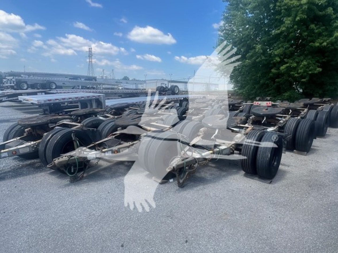 Trailer dolly chassis with multiple axles and wheels in an outdoor lot, 2015 Eagle Rock Dolly.