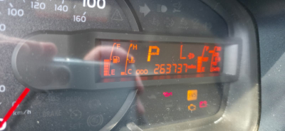 Dashboard display of a 2019 Hino 155 box truck showing gear in Park (P), odometer reading 263,737 miles, fuel gauge, and warning lights.