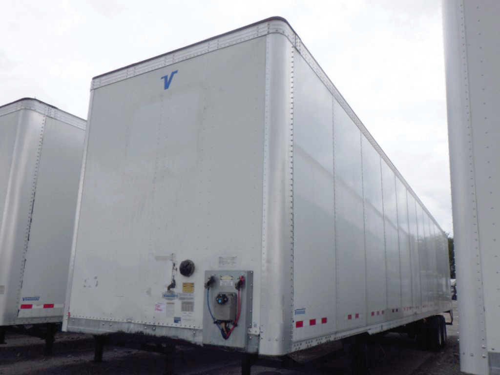 Trailer van side and rear showing Vanguard plate van with white exterior and blue 'V' logo on front corner.