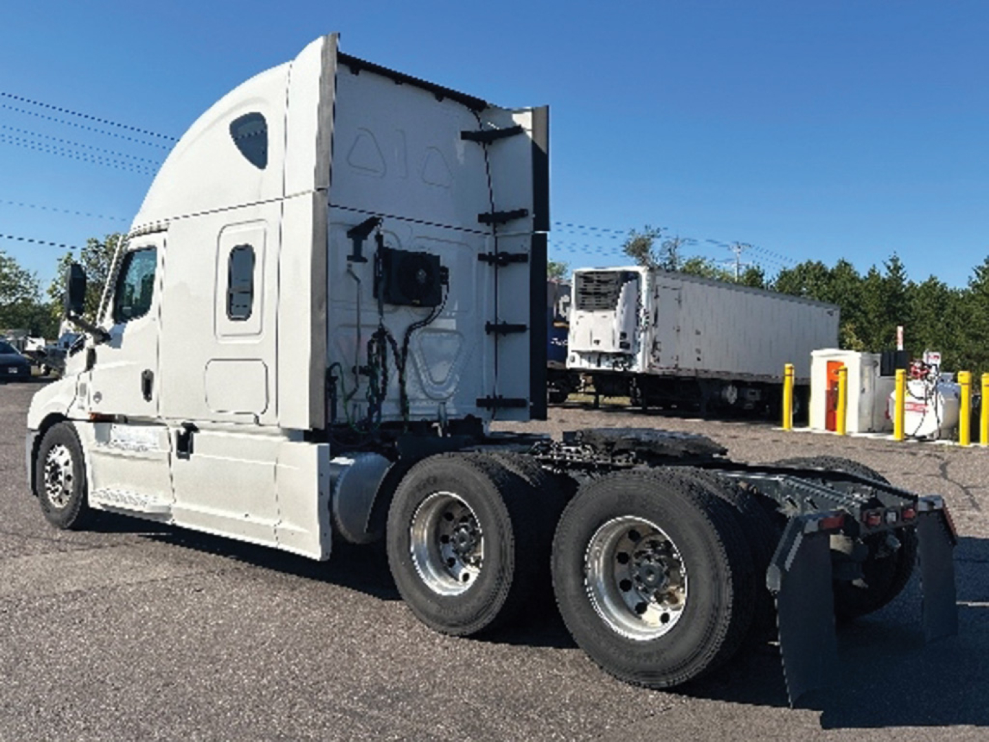 Freightliner Cascadia126 sleeper tractor side view showing cab, rear wheels, and trailer hookup area.