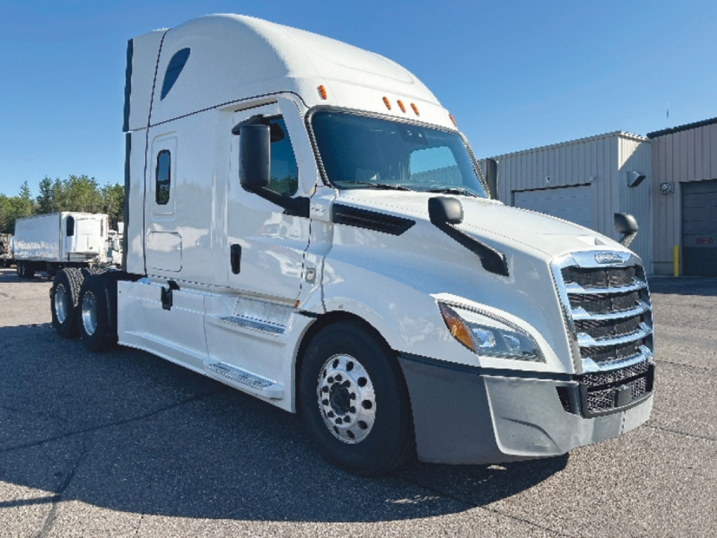 Truck engine bay? No, a Freightliner Cascadia126 sleeper tractor from front-left angle showing cab and wheel, white exterior.