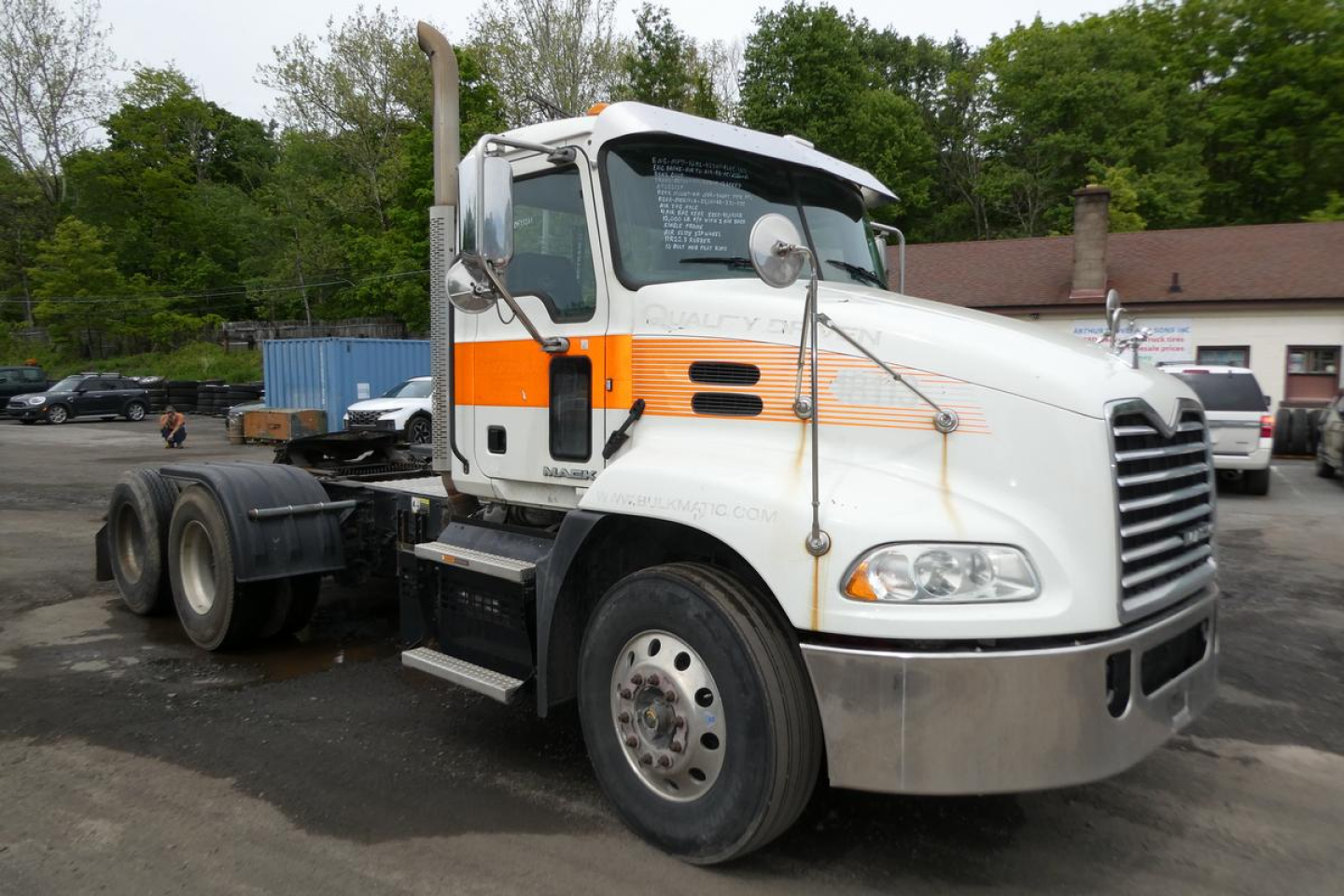 2018 Mack CXU613T conventional daycab truck front-left view showing VIN and stock info on windshield area.