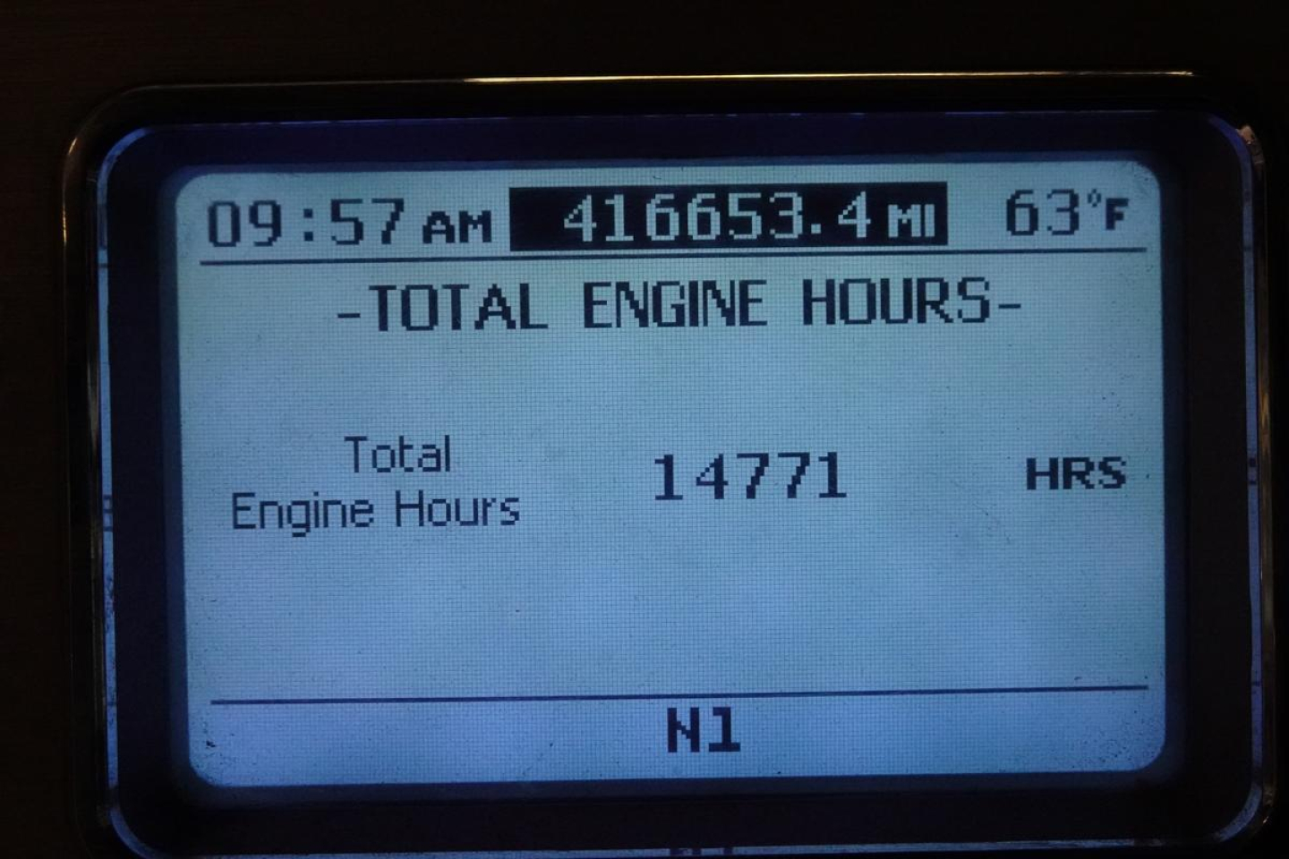 Dashboard display showing total engine hours: 14771 HRS, time 09:57 AM, mileage 416,653.4 MI, exterior temp 63°F, row N1.