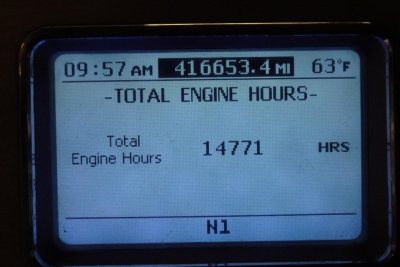 Dashboard display showing total engine hours: 14771 HRS, time 09:57 AM, mileage 416,653.4 MI, exterior temp 63°F, row N1.