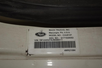 Mack Trucks label on door jamb showing MODEL NO: CXU613T and VIN 1M1AW02Y8JM089011 with barcode.