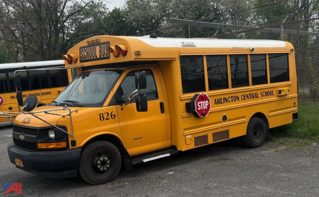 School bus showing stop sign and 'ARLINGTON CENTRAL SCHOOL' lettering on side, 2017 Chevrolet Thomas Express bus model, number 826.