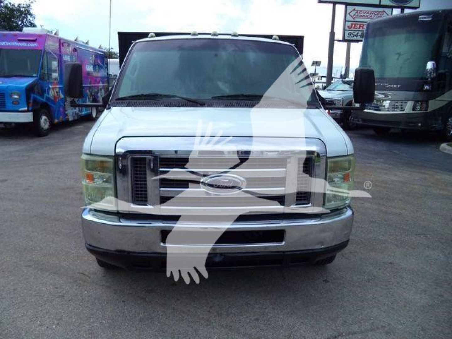 Ford E-450 service truck front view showing Ford emblem and grille with bumper and standard headlights.