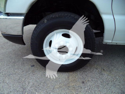 Ford E450 wheel and front tire in flatbed truck showing white steel wheel and tire sidewall