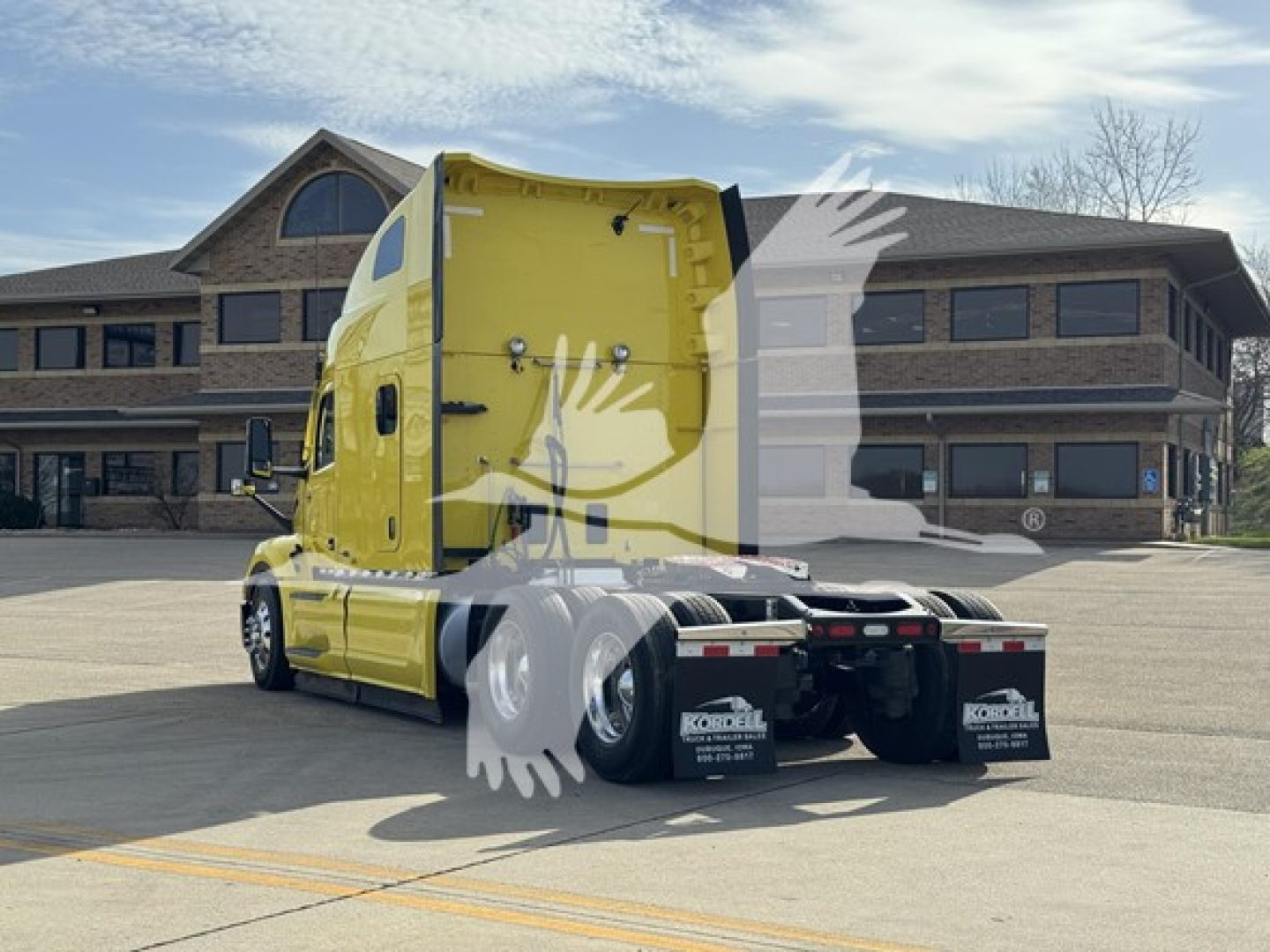 Peterbilt 579 conventional sleeper truck rear/side view showing yellow cab and sleeper with dual rear axles.