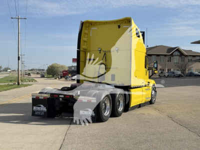 Peterbilt 579 tractor with yellow sleeper and rear chassis on a street, side view showing the cab and rear wheels.