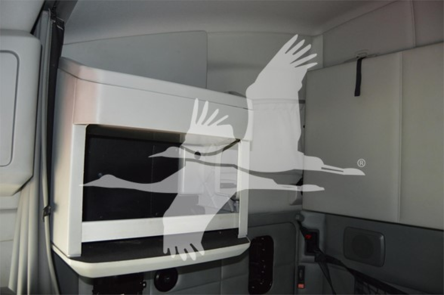 Kenworth T680 sleeper cab interior showing a microwave mounted cabinet unit.