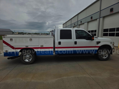 Ford F-250 service/utility truck side view showing utility bed with compartments and graphics.