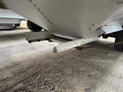 Trailer underside showing hitch and support brackets from a 2020 Timpte Super Hopper. Visible: bottom edge of hopper, mounting brackets, and trailer frame.