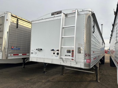 Timpte hopper trailer in a lot showing a rear ladder, Timpte nameplate, multiple valves and stickers on the back, and the number 514 on the side.