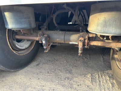 Timpte hopper trailer undercarriage showing axles, suspension, and drivetrain components.