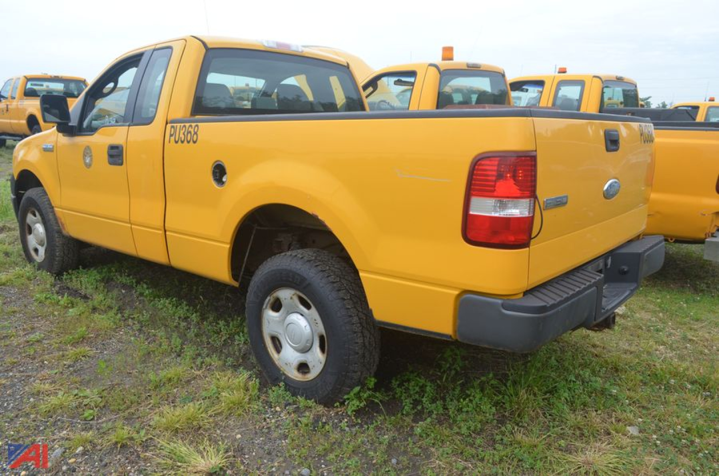 Ford F-150 pickup truck extended cab, yellow, rear-side view showing tailgate and rear wheel, 2006 model year.