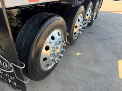Volvo VHD truck axle and wheels showing multiple lug nuts and polished rims.