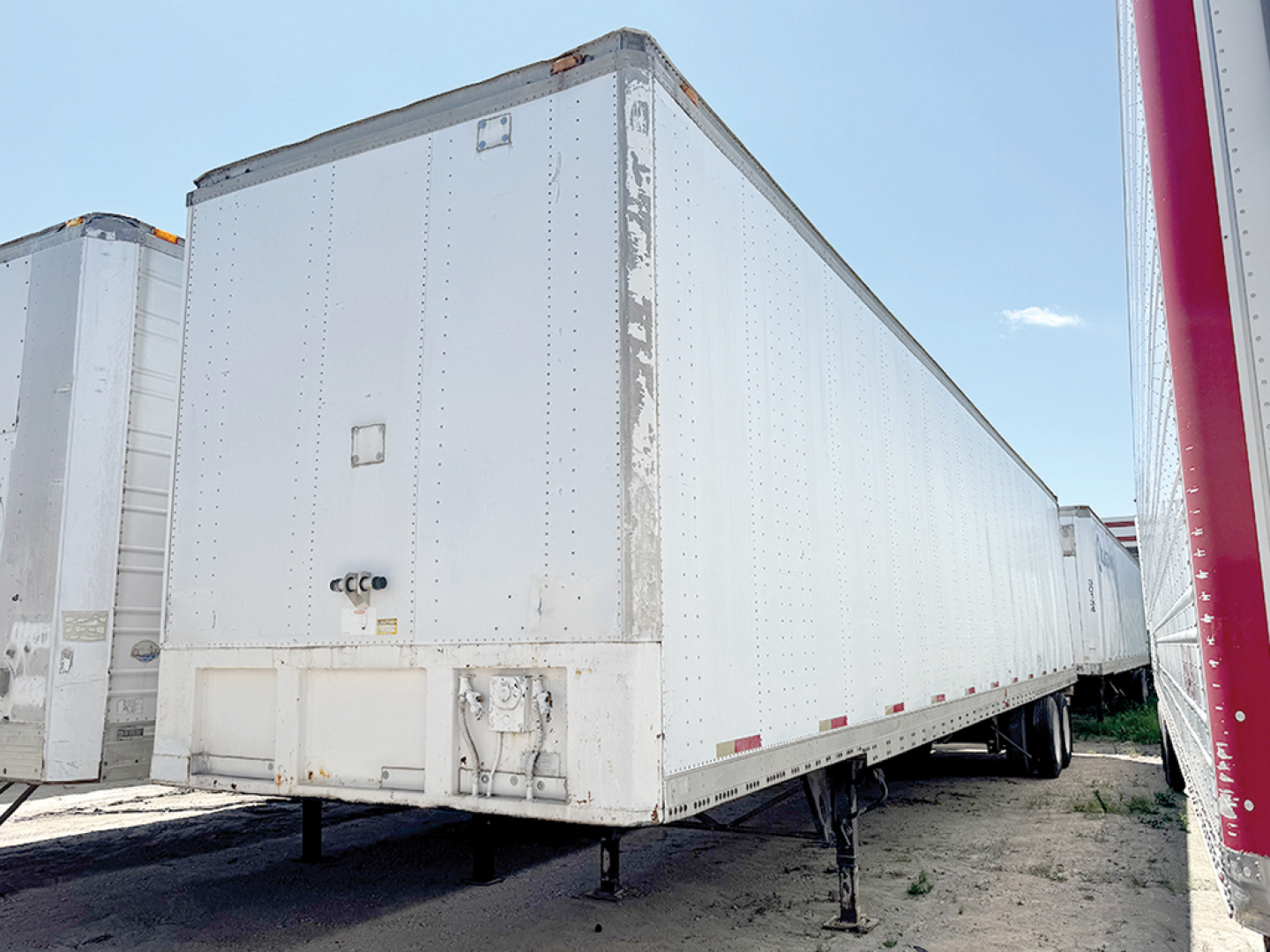 Trailer: aluminum Hobbs van trailer with legs extended and side riveted panels.