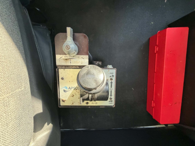 Truck interior panel showing APSCO control with a round dial and a red rectangular box nearby.