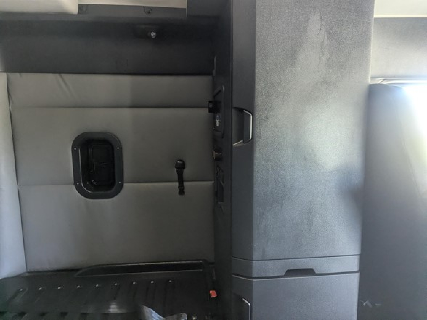 Freightliner Cascadia 126 interior cab view with side panel and door hatch