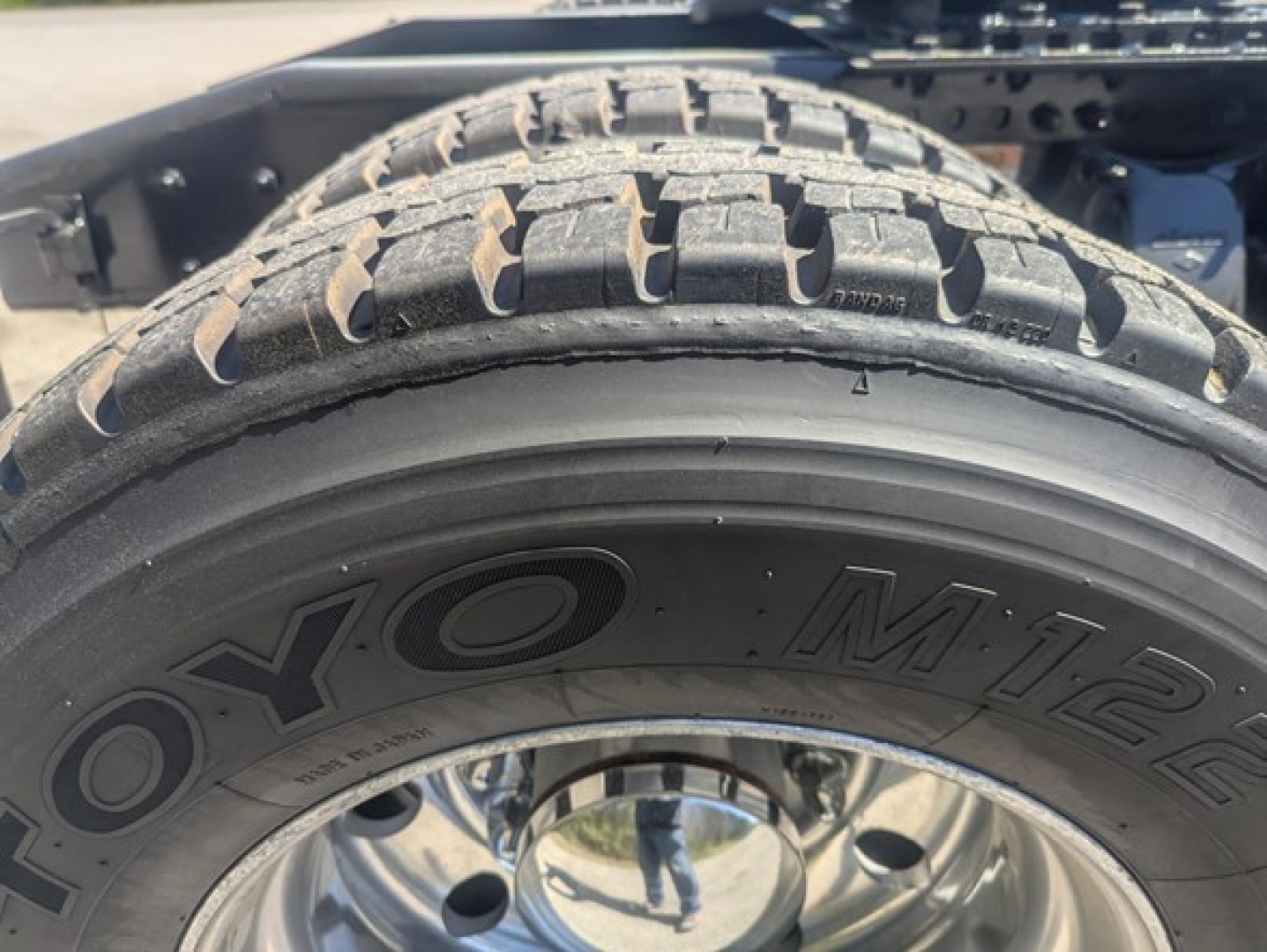 Tire close-up on Freightliner Cascadia 126 wheel with Toyo M-? tire marking. Showcases tire tread and wheel assembly.