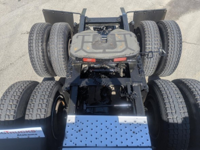 Six-wheel tractor rear chassis with dual rear axles and dual tires, top view of fifth wheel and metal step plate.