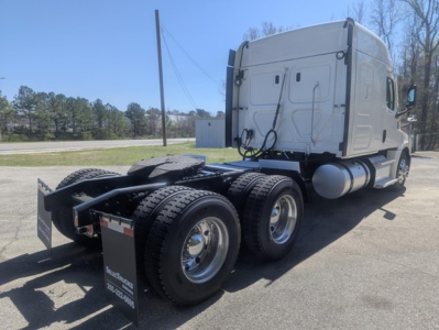 Freightliner Cascadia 126 tractor cab with dual rear axles and fifth wheel, side view showing sleeper cab and exhaust fuel tanks.