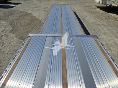 New Reitnouer Big Bubba Dropdeck trailer long aluminum deck with center beams and white bird logo at rear.