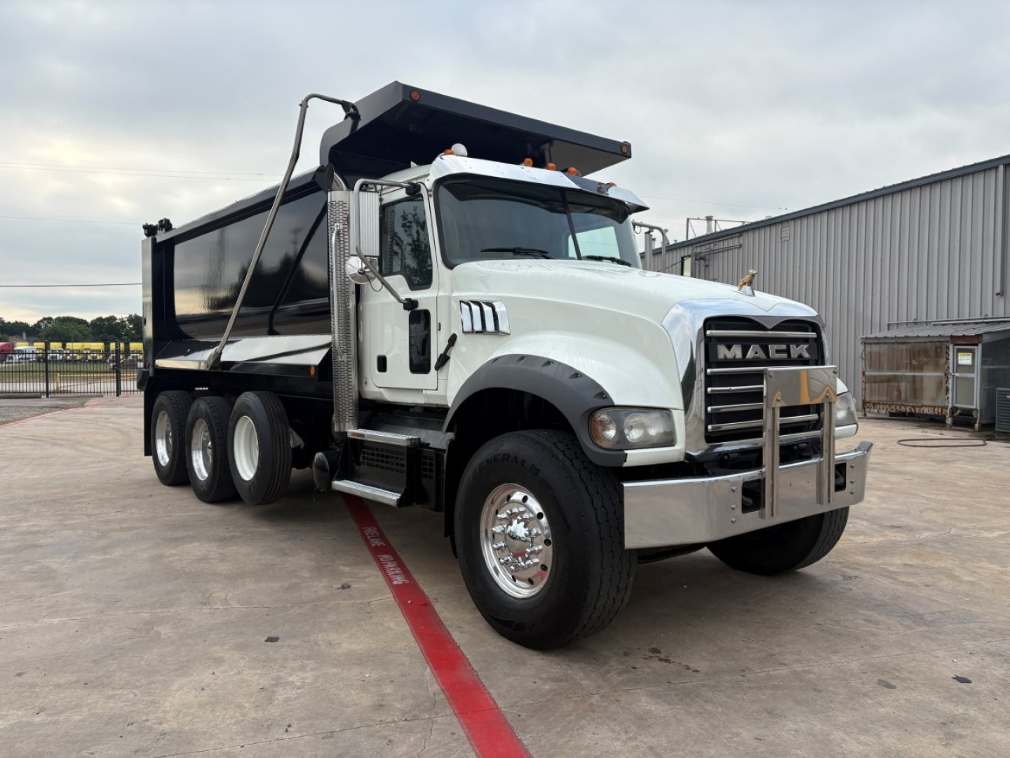 Dump truck showing cab and MAEK GR64F model front with chrome bumper and dump bed.