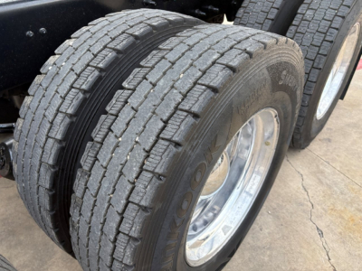 Dual rear drive tires showing tread pattern on a 2020 Mack GR64F dump truck chassis.